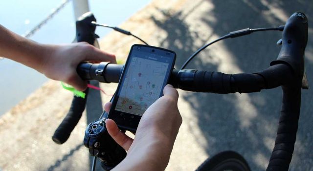 Bicyclist using BikeMaps.org to find the safest route. Credit: Karen Laberee